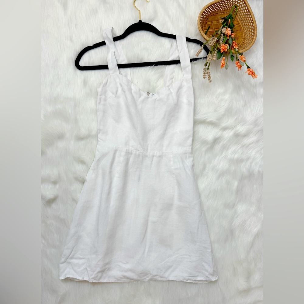 Reformation white linen mini dress with adjustable straps. Size 2
